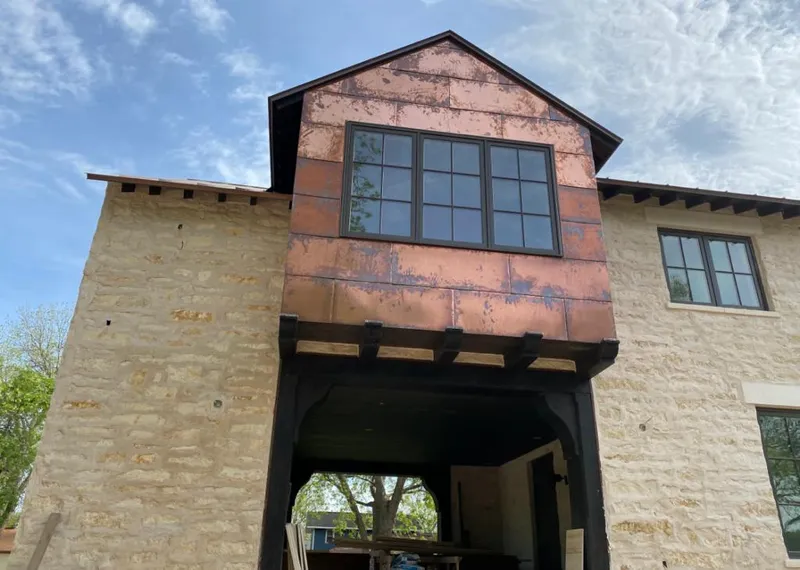 Copper metal panel facade on a stone building for Skylight Installation in Charlotte