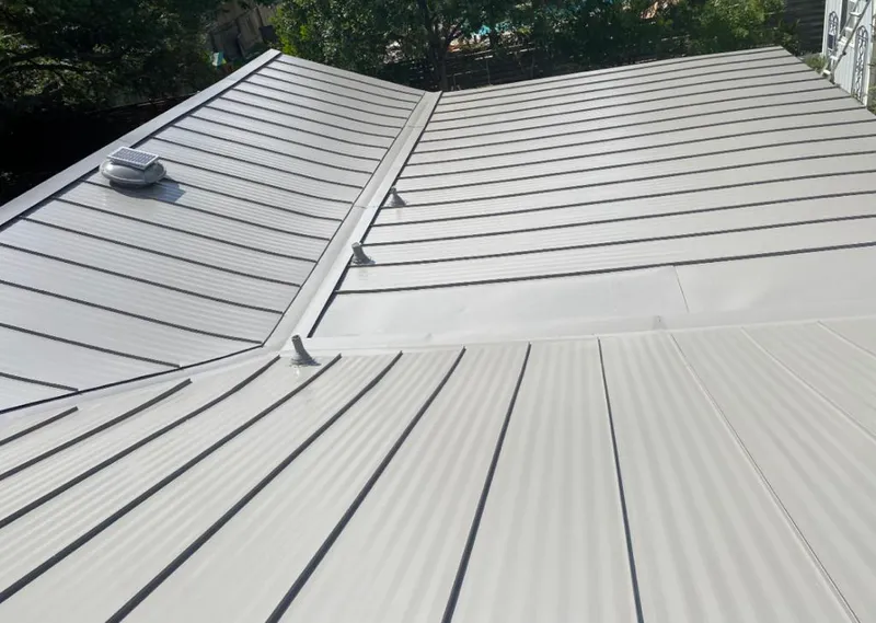 Solar attic fan installed on a metal roof for Roof Ventilation in Charlotte